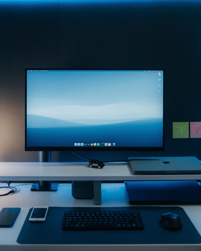 Sleek desktop workspace featuring a widescreen monitor, keyboard, and devices.